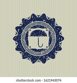 Blue umbrella icon inside distressed rubber grunge texture stamp