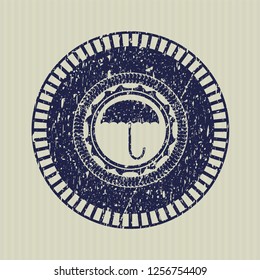 Blue umbrella icon inside rubber stamp