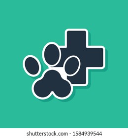 Blue Veterinary clinic symbol icon isolated on green background. Cross hospital sign. Stylized paw print dog or cat. Pet First Aid sign.  Vector Illustration