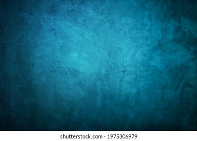 Blue wall in spots, cracks, stains. Painted aquamarine concrete wall in abstract grunge style. Grunge background texture for backgrounds, portraits, posters.
