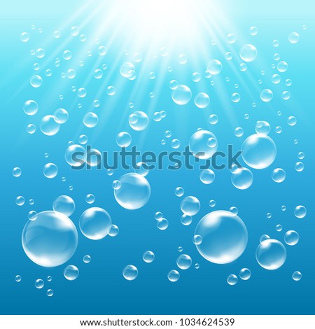 Blue water background with bubbles and sunrays shining into the water
