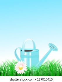 Blue watering can decorated with a daisy in garden