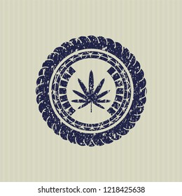 Blue weed leaf icon inside rubber seal with grunge texture