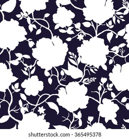 Blue and white floral seamless pattern. Hand drawn white silhouette of flowers. Vector background.