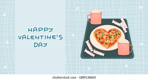 Blue and White Happy Valentines Day text. Heart shaped pizza, candies and two pink cups of hot chocolate and marshmallows are on the tray on squared blue background