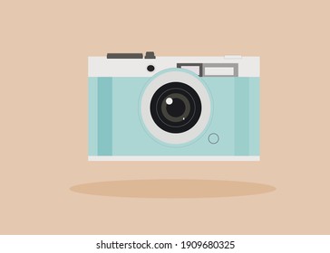 Blue and white photo camera on beige background