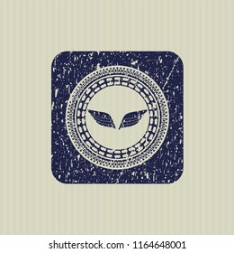 Blue wings icon inside distress rubber stamp