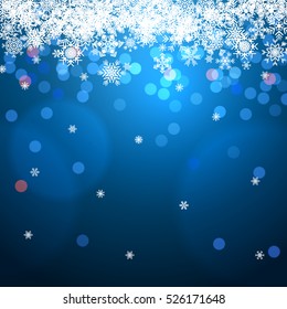 Blue winter background with bokeh and snowflakes