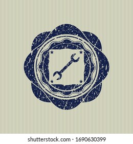 Icono de la llave azul en el interior perturbado con textura de sello de goma. 