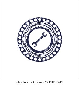 Blue wrench icon inside rubber grunge texture seal