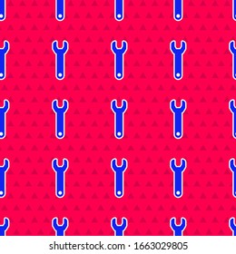 Icono de la llave inglesa azul aislado sin fisuras en el fondo rojo. Ilustración vectorial