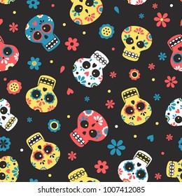 Blue, yellow and red mexican calavera day of the dead skulls with flowers on dark background seamlss pattern