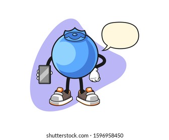 Blueberry hold smartphone with speech bubble cartoon. Mascot Character vector.