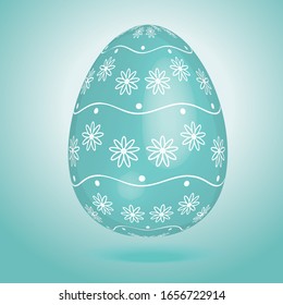 blue-green Easter egg with elements of flowers and wavy lines