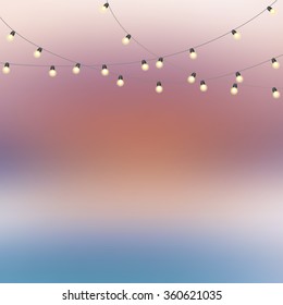 Blurred background with bokeh effect and garland with lamps. Cool template for design, presentations and other documents