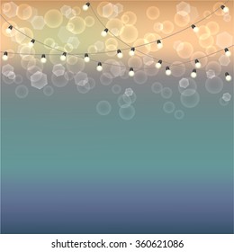 Blurred background with bokeh effect and garland with lamps. Cool template for design, presentations and other documents