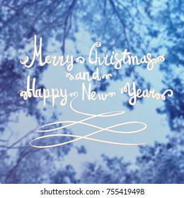 Blurred background of the branch under the snow and tex painted in chalk. Merry Christmas and a Happy New Year 2018. Happy holiday theme.