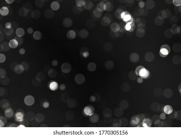 Blurred bokeh light on black background. Christmas and New Year holidays template. Abstract silver glitter defocused blinking stars and sparks. Vector EPS 10