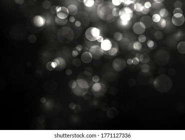 Blurred bokeh light on black background. Christmas and New Year holidays template. Abstract silver glitter defocused blinking stars and sparks. Vector EPS 10