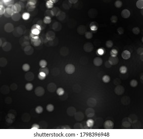 Blurred bokeh light on black background. Christmas and New Year holidays template. Abstract silver glitter defocused blinking stars and sparks. Vector EPS 10