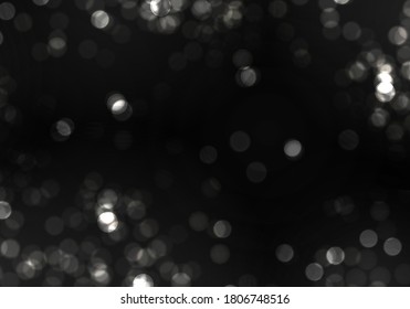 Blurred bokeh light on black background. Christmas and New Year holidays template. Abstract silver glitter defocused blinking stars and sparks. Vector EPS 10