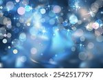 Blurred light blue and silver background with sparkling stars for a Christmas or New Year