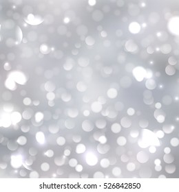 blurred silver bokeh background with soft lilac and pink colors. Holiday lights 
