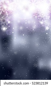 Blurred silver Christmas winter background with sparkles and snowflakes.