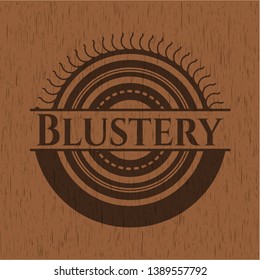 Blustery badge with wood background