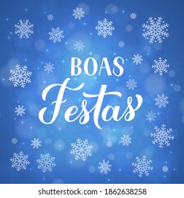 Boas Festas calligraphy isolated on blue background with bokeh and snowflakes. Happy Holidays lettering in Portuguese. Christmas typography poster. Vector template for greeting card, banner, flyer.