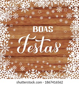 Boas Festas calligraphy on wood background with snowflakes. Happy Holidays hand lettering in Portuguese language. Christmas typography poster. Vector template for greeting card, banner, flyer, etc.