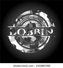 Bobbin on grey camouflaged pattern