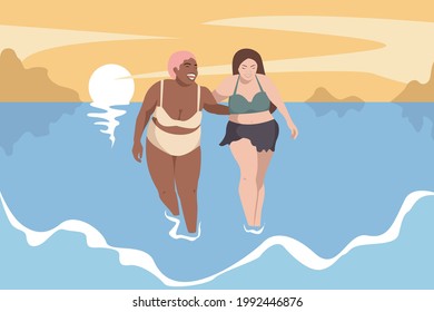 Body positive concept. In summer, two beautiful and happy girlfriends in swimsuits walk along the beach by the sea. Women are plus size models. Love your body.