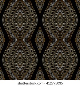 Bohemian abstract vector seamless geometrical pattern from gold and black hand drawn rhombus, Eskimo ornaments, lacy wavy stripes. Textile fantasy print. Wrapping paper. Batik painting