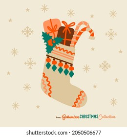 Boho Christmas stocking filled with gifts and candy cones. Bohemian Christmas socks isolated. Great symbol for Christmas cards, posters, stickers, wall art. Hand drawn in flat cartoon simple style