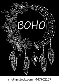 Boho dreamcatcher with flowers, notes and feathers.