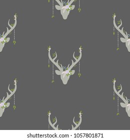 boho seamless pattern with deer head with antlers, feathers and flowers, green leaves and wild berry sprig. Wild nature ornament on grey background. Ethnic vector print for paper and fabric