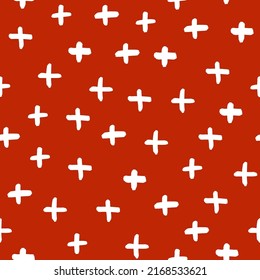 Boho seamless pattern with white crosses and brown background.