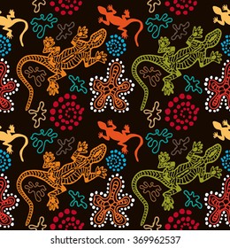 Boho style seamless pattern with Australian aboriginal arts motifs. Hand drawn lizards, stones, sand, fantasy flowers. Ethnic textile collection. Colorful on dark. Backgrounds & textures shop.