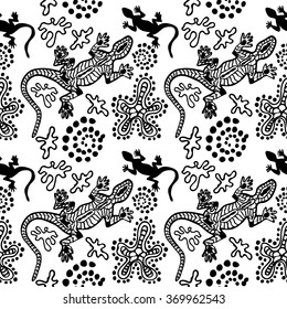 Boho style seamless pattern with Australian aboriginal arts motifs. Hand drawn lizards, stones, sand, fantasy flowers. Ethnic textile collection. Black & white. Backgrounds & textures shop.