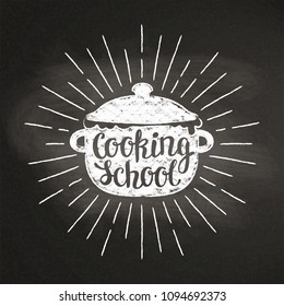 Boiling pot chalk silhoutte with sun rays and lettering - Cooking school - on blackboard. Good for cooking logotypes, bades or posters.