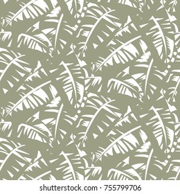 Bold abstract jungle print with silhouette of paradise island foliage. Vector seamless floral green pattern inspired by tropical nature and plant with shape of banana leave and tree. Summer background