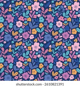 Bold floral pattern in hand drawn style. Colorful small flowers on dark blue background. Ditsy seamless print design for kids fabrics, wallpaper or wrapping paper. 