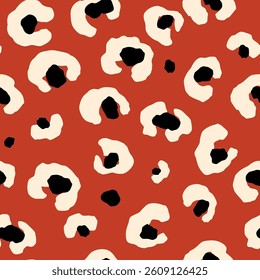 Bold leopard skin seamless pattern. Abstract hand drawn blobs on the red repeat background. Tropical wild print decorated animal skin. Summer vector illustration for surface, fabric, textile design