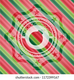 bomb icon inside christmas style badge..