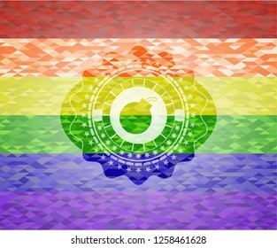bomb icon inside emblem on mosaic background with the colors of the LGBT flag
