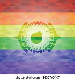 bomb icon inside emblem on mosaic background with the colors of the LGBT flag