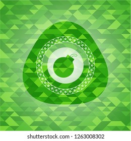 bomb icon inside green emblem with mosaic background