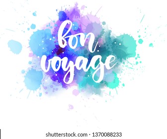 Bon voyage - handwritten modern calligraphy lettering text on abstract watercolor paint splash background.