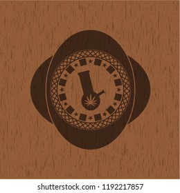 bong of marijuana icon inside badge with wooden background